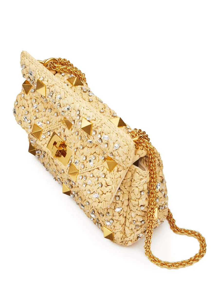 Medium Roman Stud The Shoulder Bag in Raffia with Chain and Rhinestones